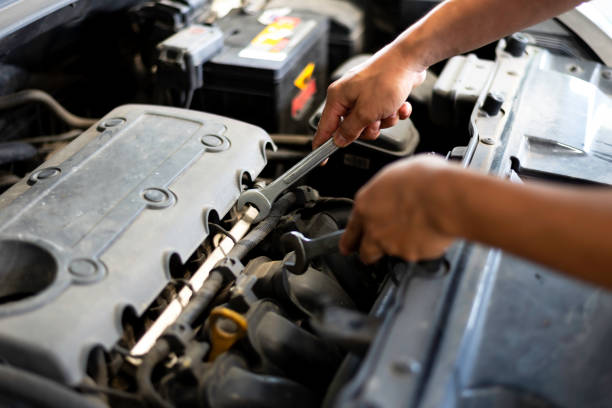 Car care maintenance and servicing, Close-up hand technician auto mechanic using the wrench to repairing change spare part car engine problem and car insurance service support.