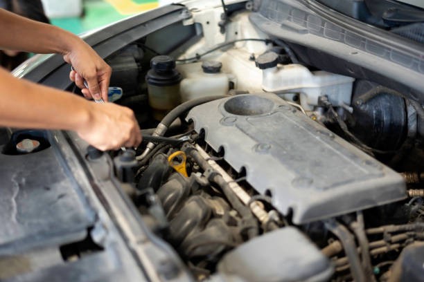 Car care maintenance and servicing, Close-up hand technician auto mechanic using the wrench to repairing change spare part car engine problem and car insurance service support.
