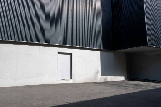 Sunlight shining on asphalt road in front of modern building