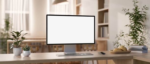 istock A computer mockup and objects are on a wooden table in a contemporary minimalist co-working space. 2152993073