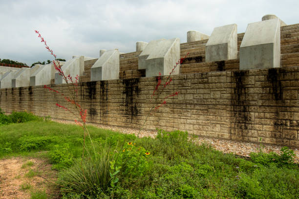 On a sunny and cloudy day, there is a small white church on a rock wall