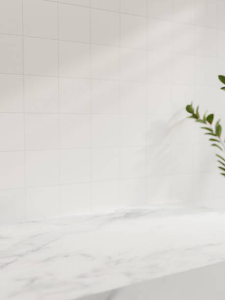 istock A space on a white marble countertop against the white tile wall with daylight shadow. 2152993425