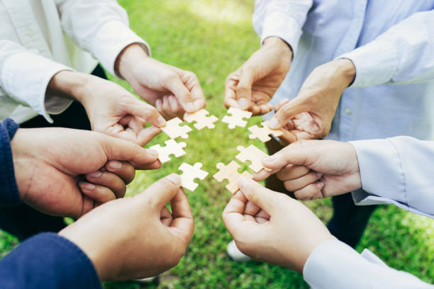 istock group of business people assembling jigsaw puzzle. The concept of cooperation, teamwork, help and support in business. 2152994482