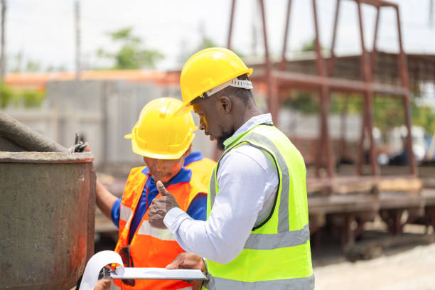 istock Foreman and worker checking project at the precast concrete factory site, Engineer man and builders team in hardhats discussing on construction site 2152996147