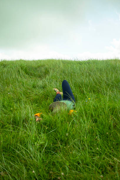 A young woman laying in lovely lush grass