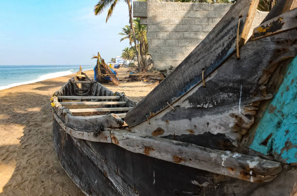 Old wooden fishing boat on tropical Indian sandy beach