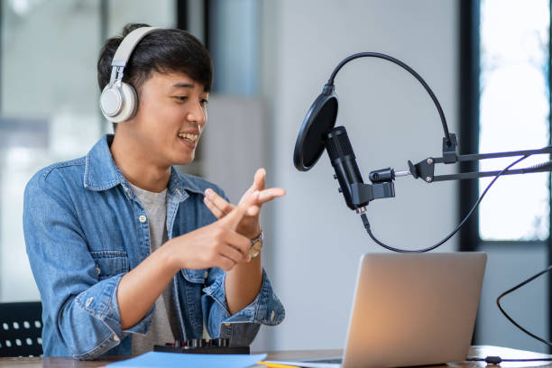 istock Modern man chatting and recording podcasts in studio 2153000517