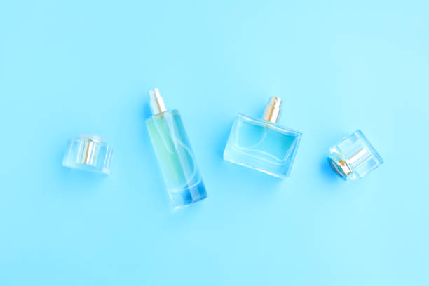 istock Perfume bottle on blue background, Glass bottle of perfumery 2153000654