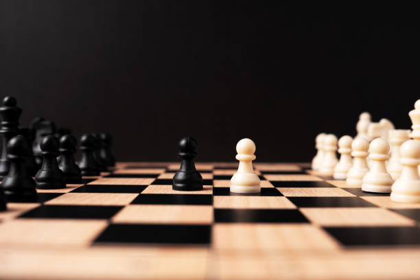 istock White pawn chess face off with black pawn chess 2153001879