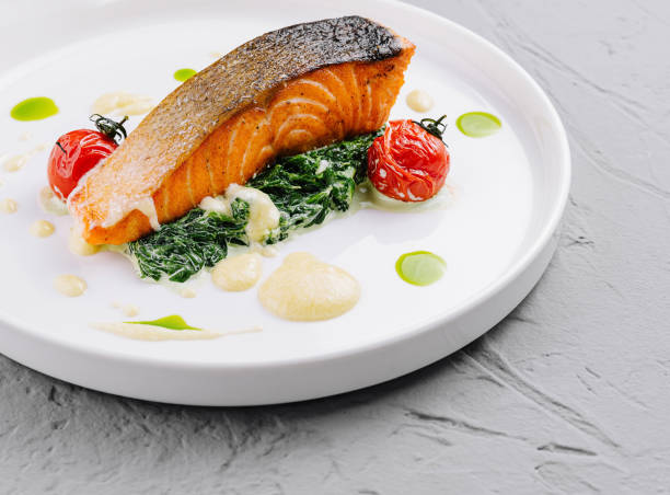istock Gourmet grilled salmon with spinach and tomatoes 2153007217