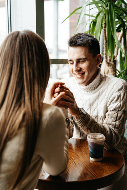 istock Smiling Man Engaged in a Casual Conversation at a Cozy Cafe During Daytime 2153007452