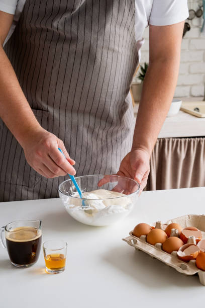 istock man wearing apron cooking tiramisu at kitchen 2153007981
