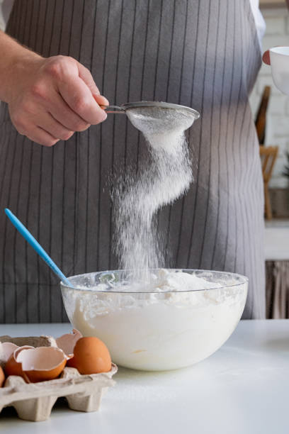 istock man wearing apron cooking tiramisu at kitchen 2153008149