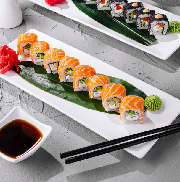 istock Exquisite sushi assortment on white plates with soy sauce and wasabi, perfect for culinary backgrounds 2153009111