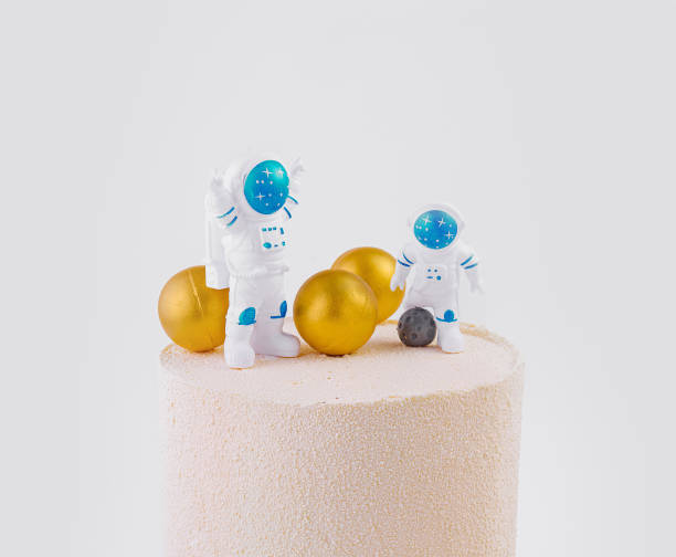 istock Space-themed birthday cake with astronaut figures 2153009513