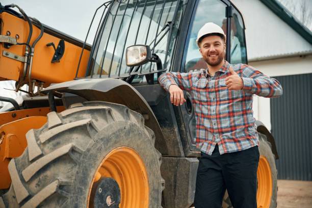 istock Leaning on the vehicle. Man is with tractor. Agricultural worker 2153010816