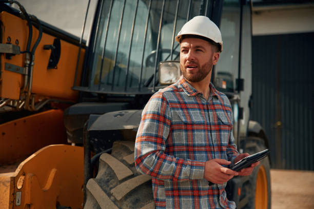 istock Digital tablet in hands. Man is with tractor. Agricultural worker 2153010956