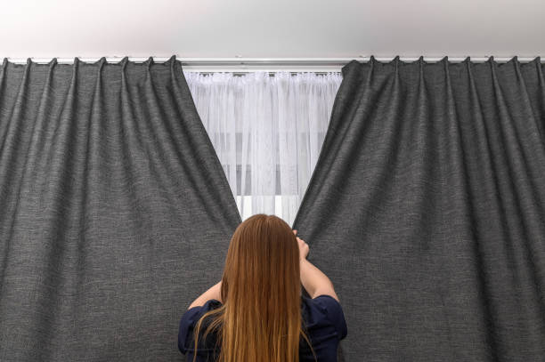 istock Woman covers bedroom window, privacy 2153012753