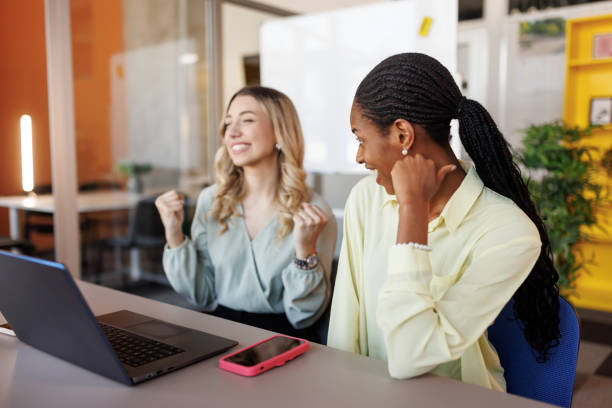 istock Happy young female colleagues cheering in office 2153015163