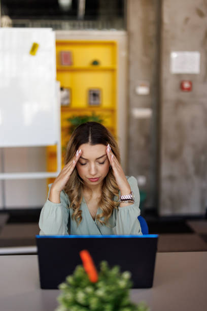 istock Businesswoman suffering from headache on workplace 2153015474