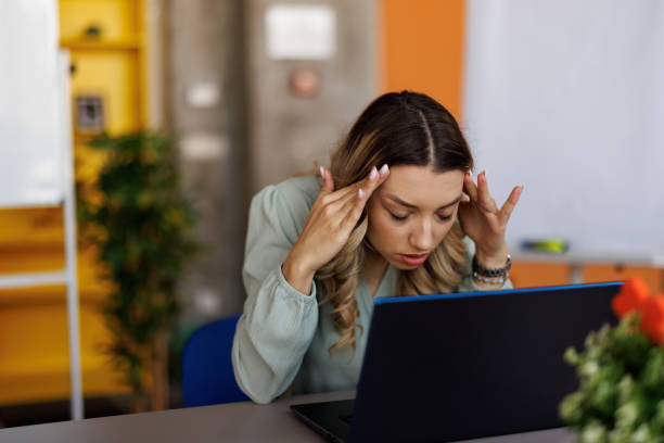 istock Businesswoman suffering from headache on workplace 2153016383