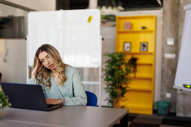 istock Businesswoman suffering from headache on workplace 2153016856