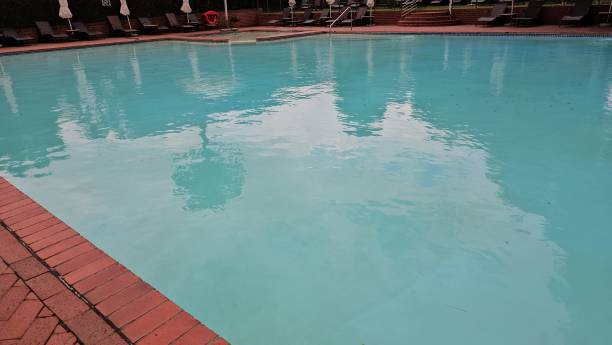 istock Relaxing Poolside Scene With Lounge Chairs 2153016935