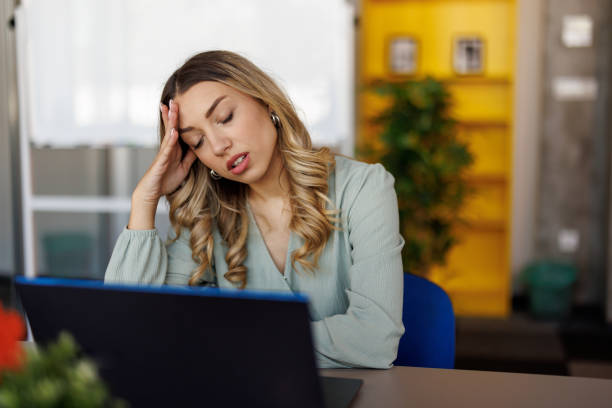 istock Businesswoman suffering from headache on workplace 2153016977