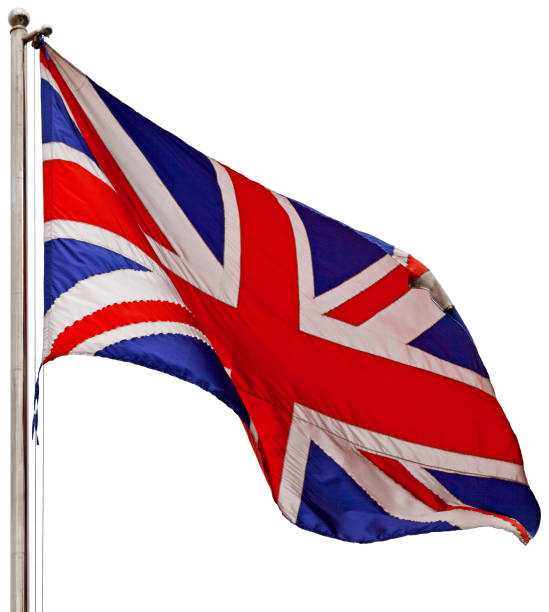 A small Union Jack flag stands in focus with a vintage bookshelf in the background. The image represents British intellectual heritage, education, literature, and English language culture. Ideal for academic, educational, or cultural themes.