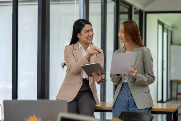 istock Two Asian businesswomen working Creative discussion in office using laptop and tablet, business concept 2153019269