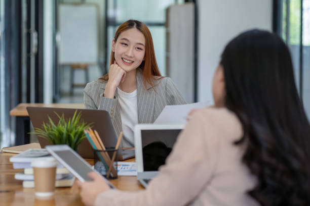 istock Two Asian businesswomen working Creative discussion in office using laptop and tablet, business concept 2153019950
