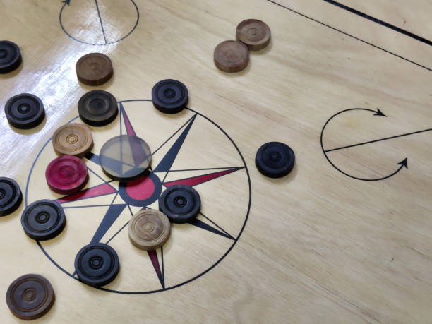 istock Carrom board with carrom coins and striker 2153020379