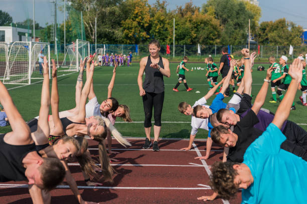 istock Female coach and group of children conducts a training session 2153021154
