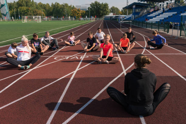 istock Female coach and group of children conducts a training session 2153021375