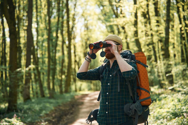 istock Tourist with binoculars. Bearded man is in the forest at daytime 2153021563