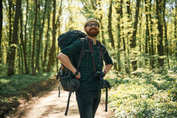 istock Front view. Bearded man is in the forest at daytime 2153022106