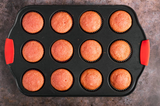 istock Cupcakes fresh from the oven on a tray. Top view. 2153022832