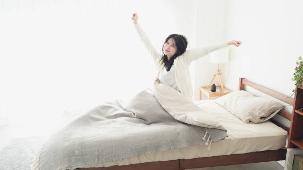 istock A woman who wakes up and stretches 2153023799