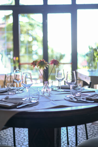 istock Tasteful table arrangement with flowers and glassware, bathed in soft daylight 2153024035