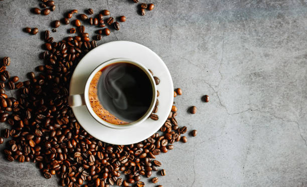 istock Overhead view of black coffee cup aromatic . Coffee cup and coffee beans on  gray background 2153024056