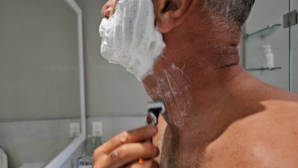 istock Man Shaving His Neck in Front of a Mirror 2153024523