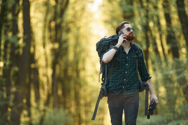istock Smartphone in hand. Bearded man is in the forest at daytime 2153024684