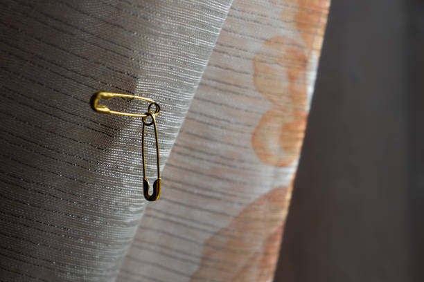 istock Safety pins hanging from the curtains 2153026363