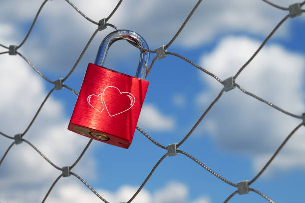 istock a single red love lock with two hearts hangs on a bridge railing 2153028296