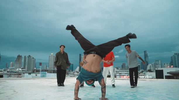 istock Hispanic hipster dancing surrounded by multicultural friend at city. Endeavor. 2153028996