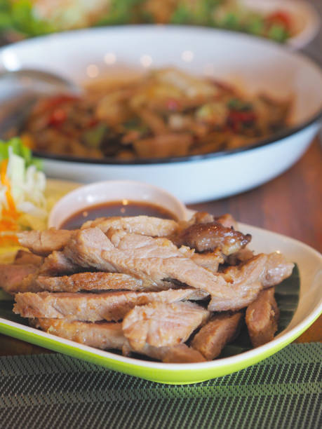 istock sliced roast pork with spicy sauce. 2153029731