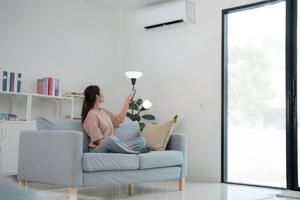 istock Woman enjoying air conditioning at home 2153032117