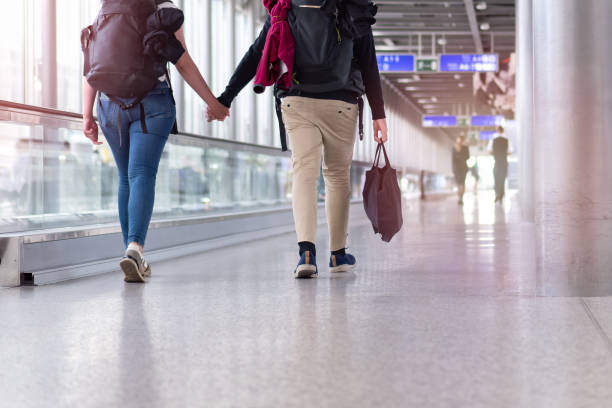 istock Unrecognizable people walking with suitcase in airport terminal 2153033510