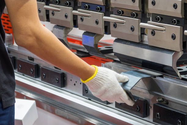 istock Close up the bending machine operator hold the sheet metal parts. 2153033828