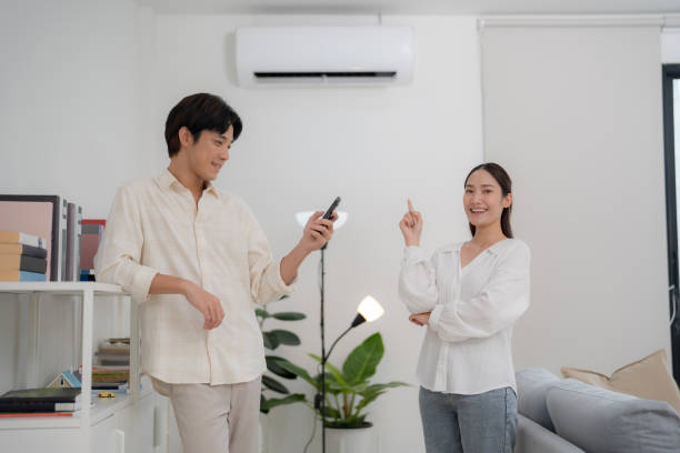 istock Couple enjoying air conditioning at home 2153034565